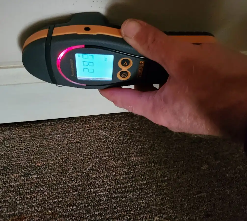Moisture detection at baseboard during Storm Damage Restoration in Yorkville